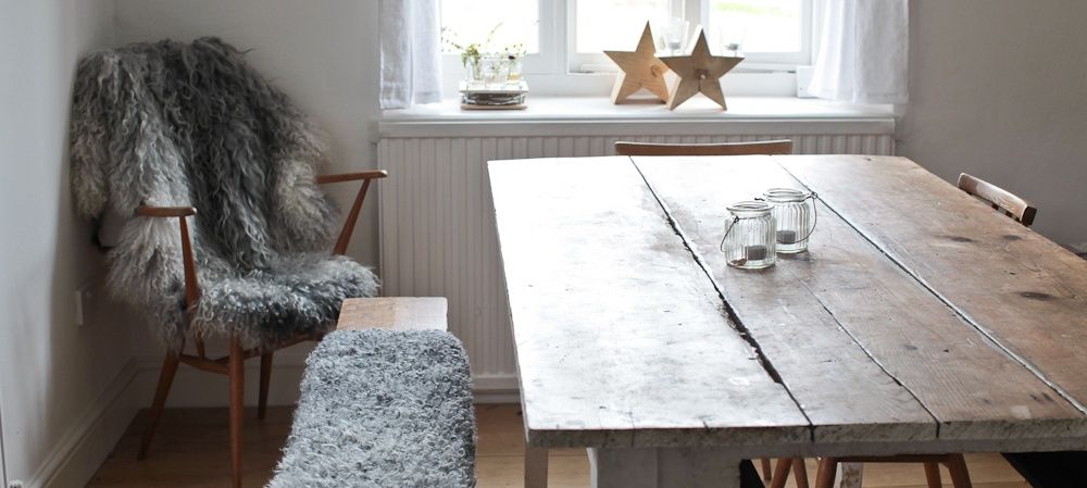 Grey sheepskins laid over a table and chair